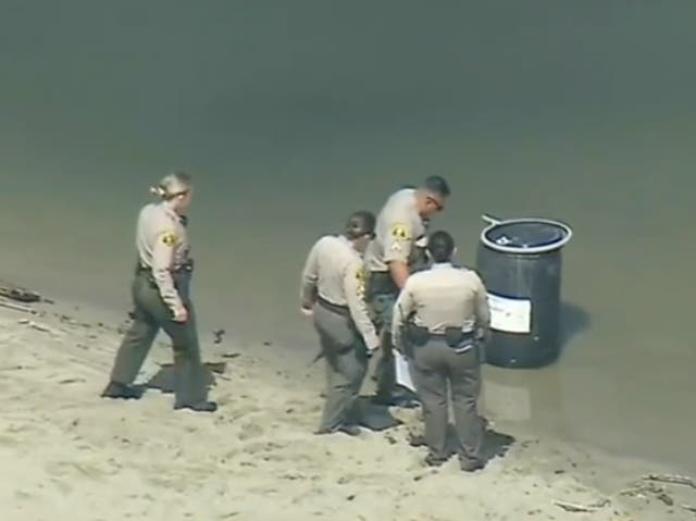 <p>Los Angeles County Sheriff’s deputies examine a barrel floating in Malibu Lagoon. The remains of aspiring rapper Javonnta Murphy, 32, were found inside the container</p>