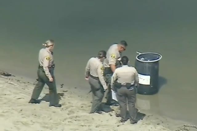 <p>Los Angeles County Sheriff’s deputies examine a barrel floating in Malibu Lagoon. The remains of aspiring rapper Javonnta Murphy, 32, were found inside the container</p>