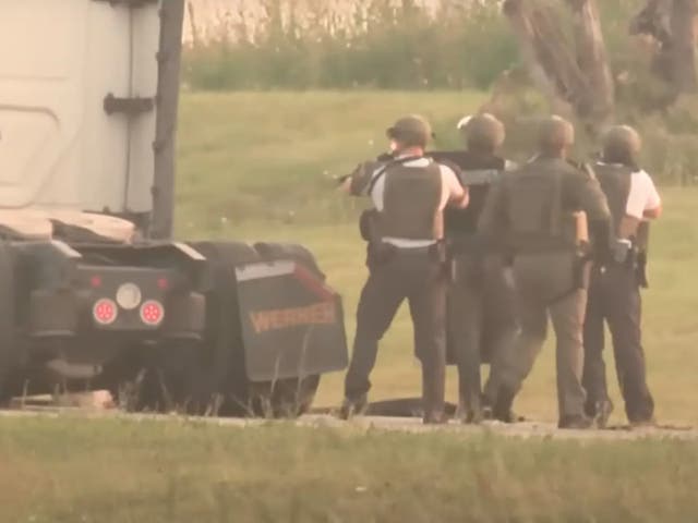 <p>Members of the Ohio State Highway Patrol’s special response team approach a truck that had been hijacked by an elderly couple</p>