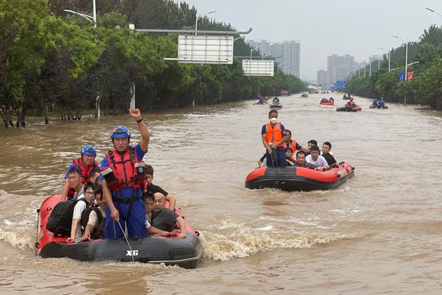<p>Residents are evacuated by rubber boats through flood waters in Zhuozhou in northern China</p>