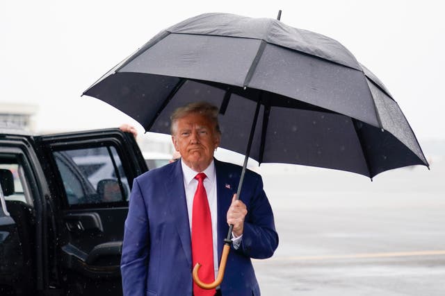 <p>Former President Donald Trump walks over to speak with reporters on tarmac after his arraignment </p>