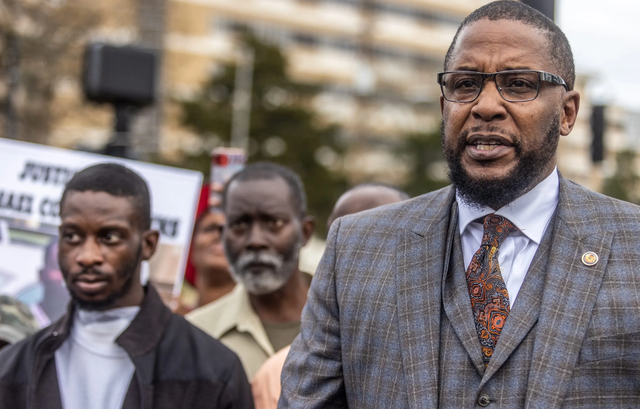 <p>One of the victims, Michael Jenkins, with lawyer Malik Shabazz</p>