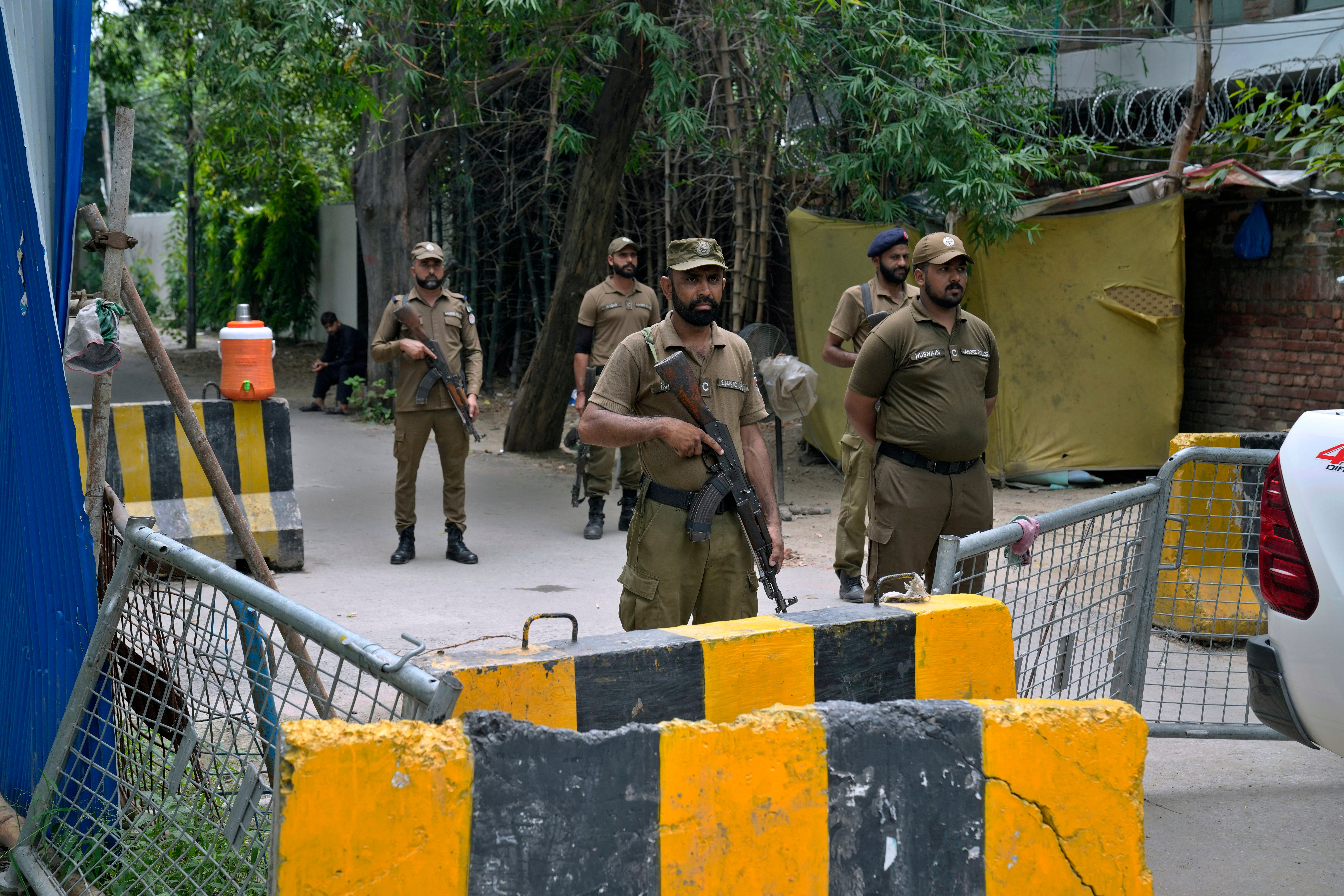 Police officers stand guard outside the residence of Pakistan's former prime minister Mr Khan on Saturday