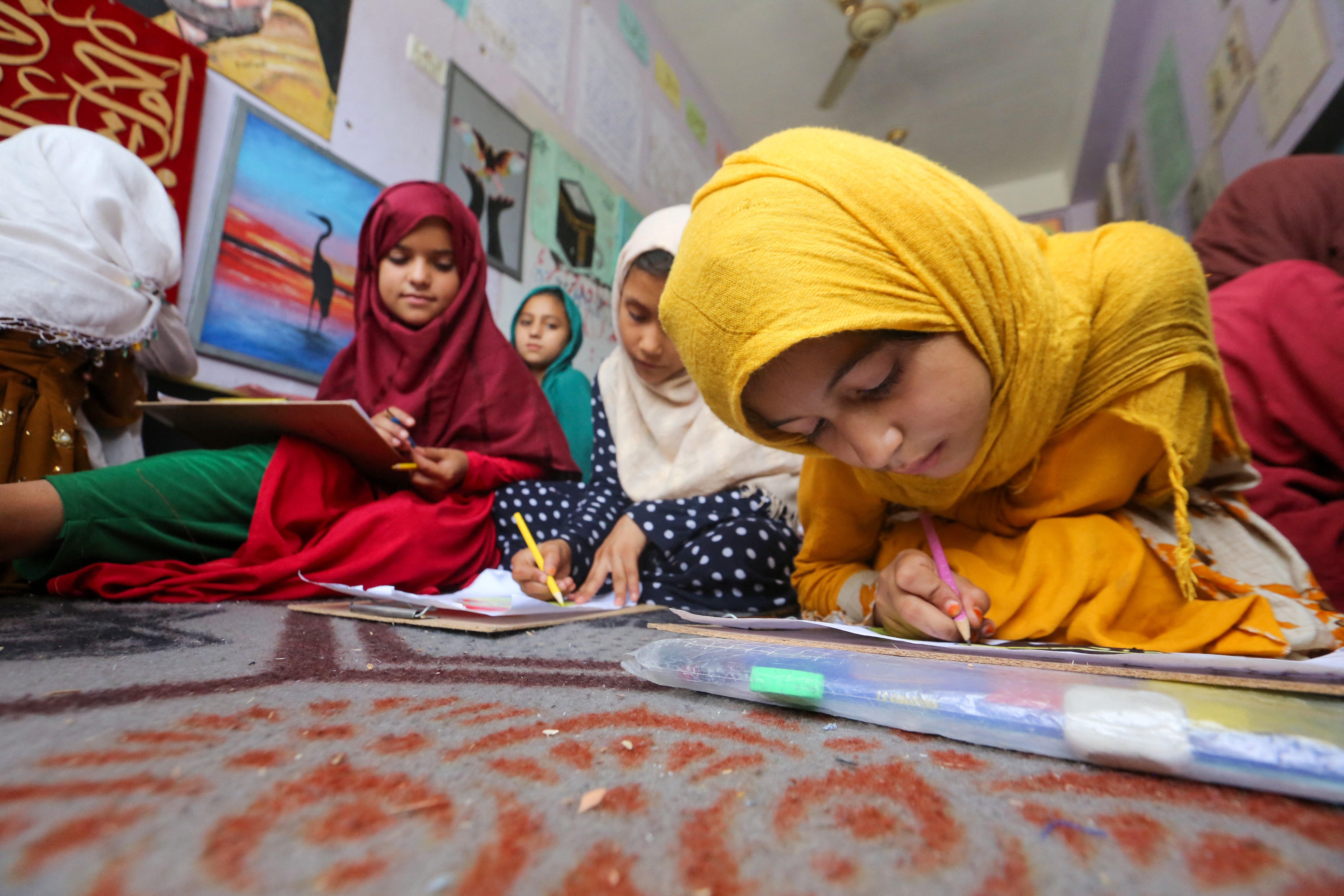 Afghan orphan girls attend a class in Jalalabad last month