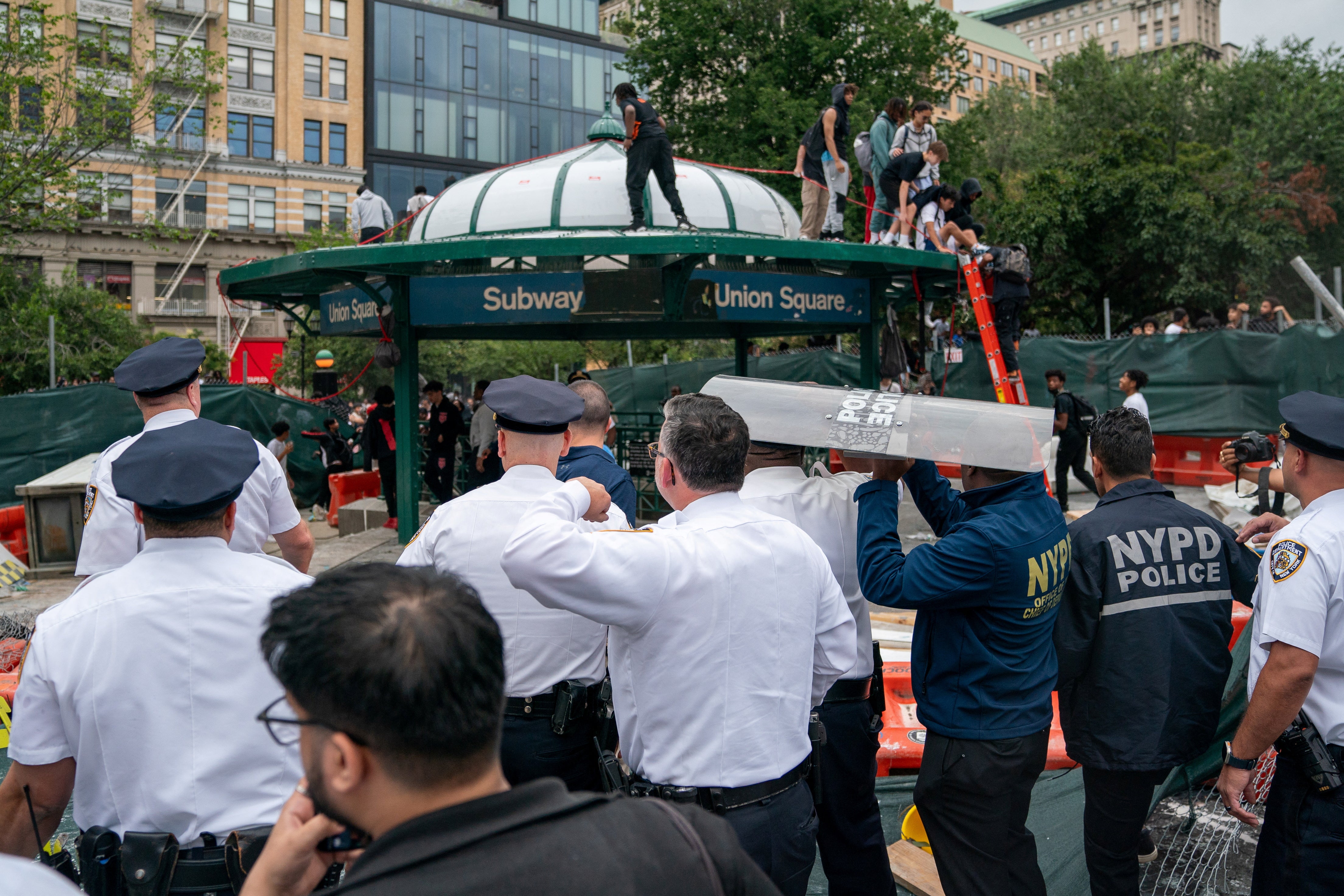 Police officers stand watch as they respond to a ‘giveaway’ event announced by Kai Cenat