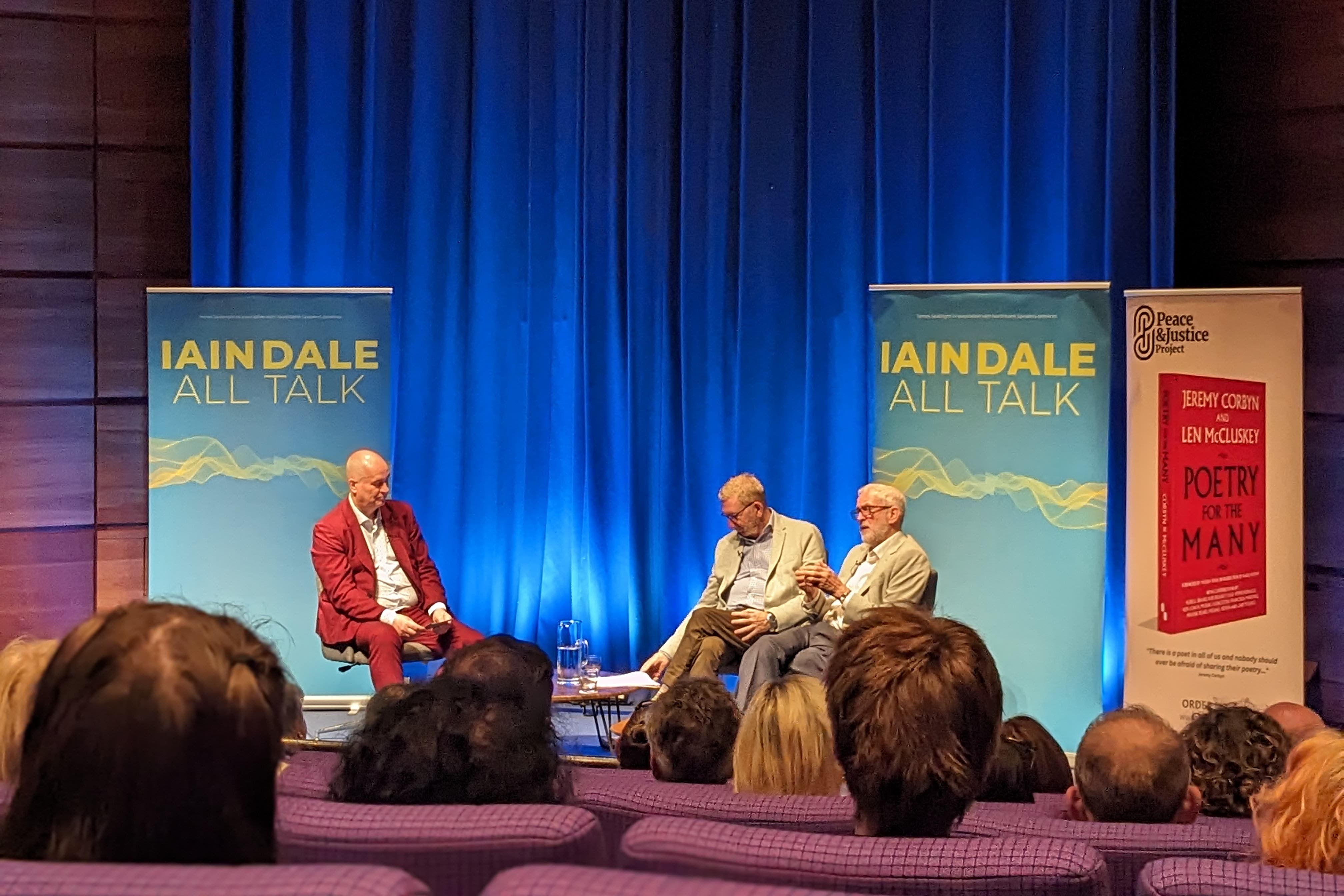 Iain Dale, Len McCluskey and Jeremy Corbyn on stage (Lauren Gilmour/PA)