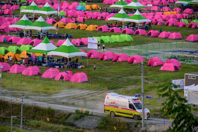 <p>An ambulance drives out of the campsite of the World Scout Jamboree amid concerns for young people’s safety </p>