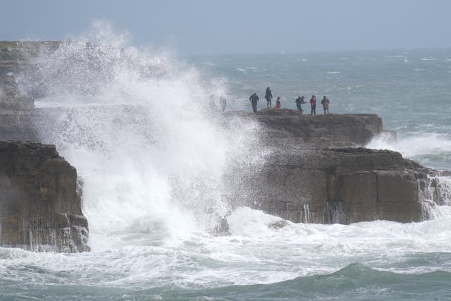 <p>Waves crash against the shore in Portland, Dorset </p>