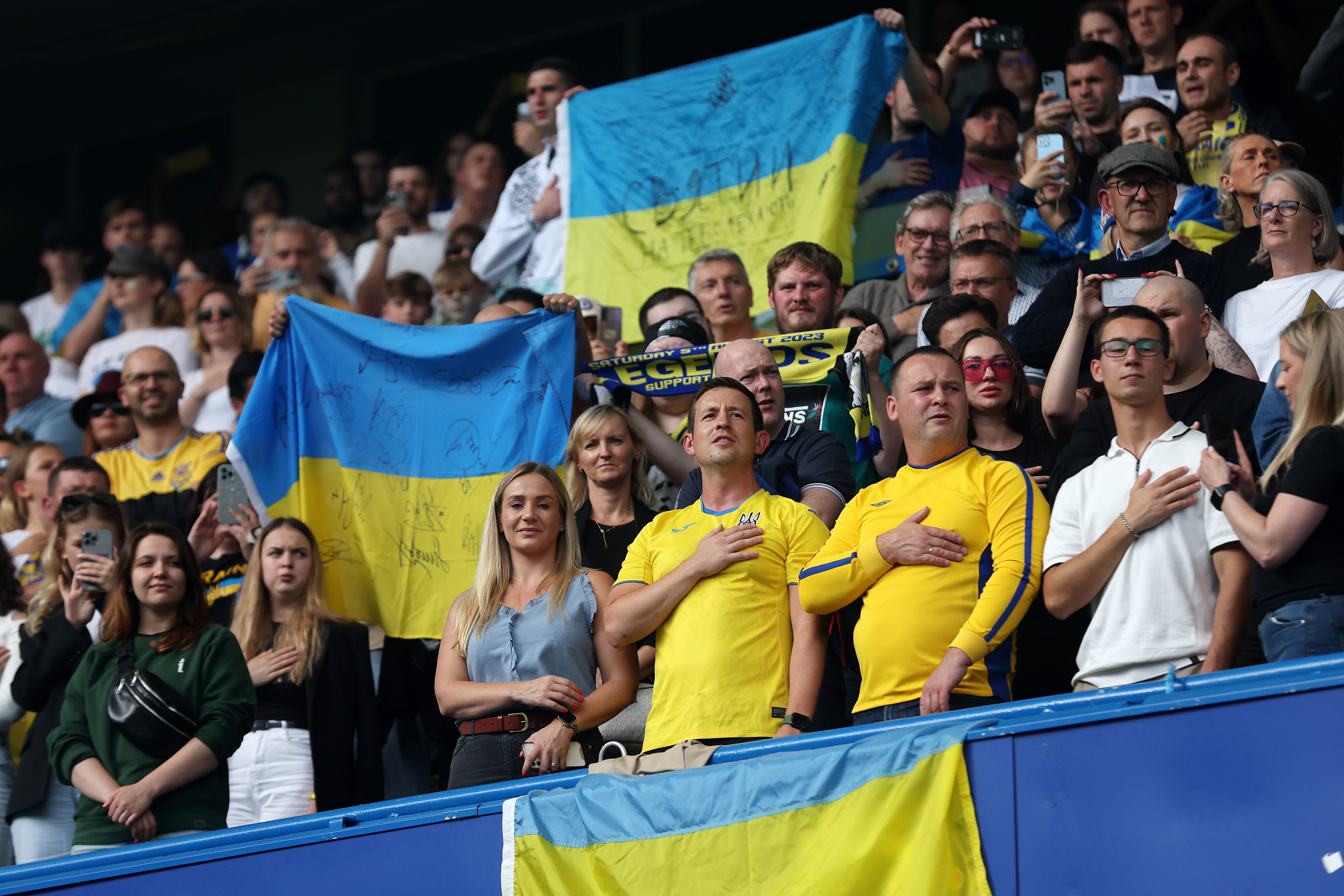 Ukraine fans sing the national anthem before kick-off