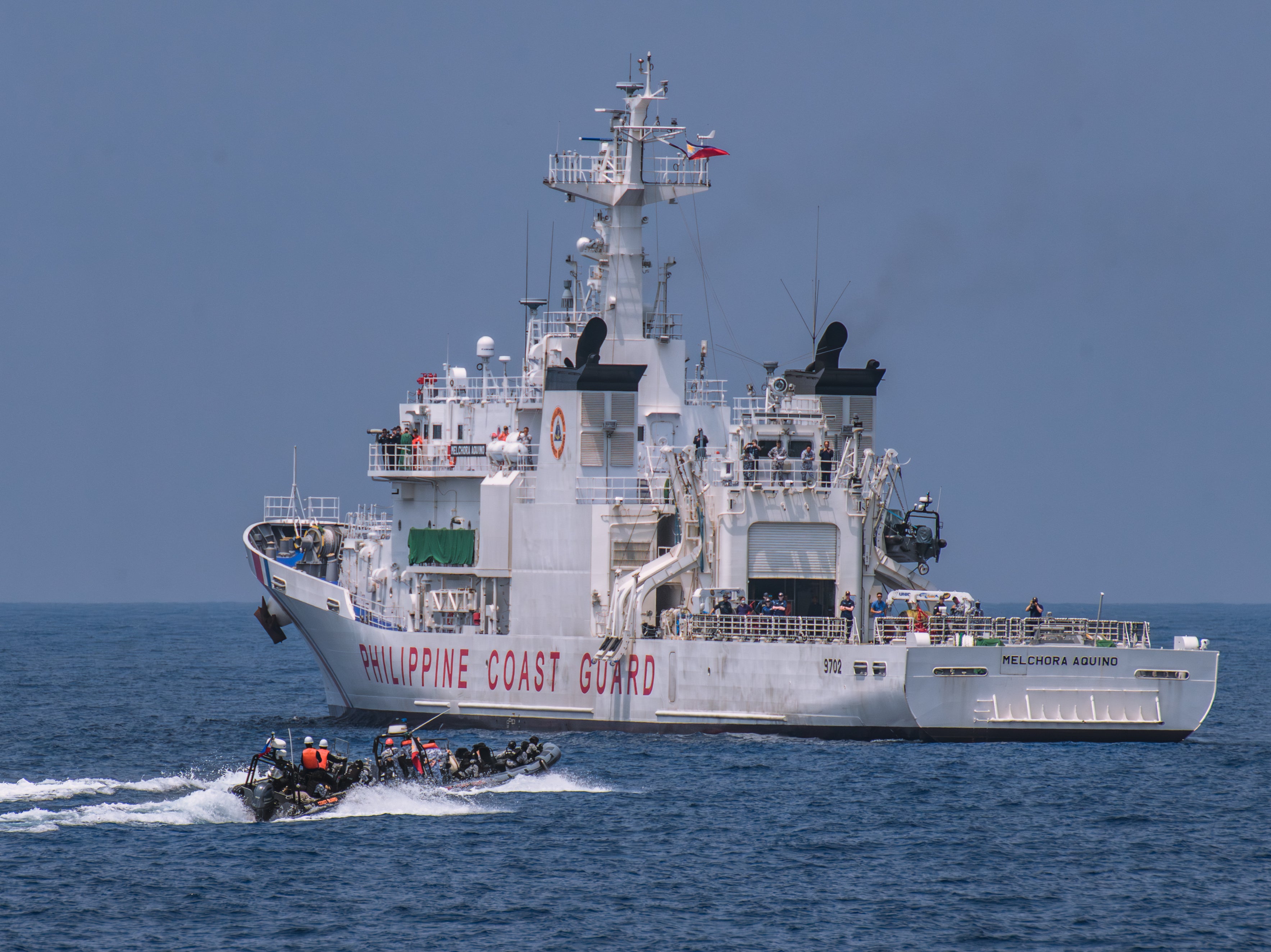 File. Members of the Philippine Coast Guard take part in a simulation during a trilateral maritime exercise with Japan and USA coast guard on 6 June 2023, 15 nautical miles off the coast of Bataan province, western Philippines. The drills that took place in waters facing South China Sea included maneuverings, maritime law enforcement, and search and rescue at sea