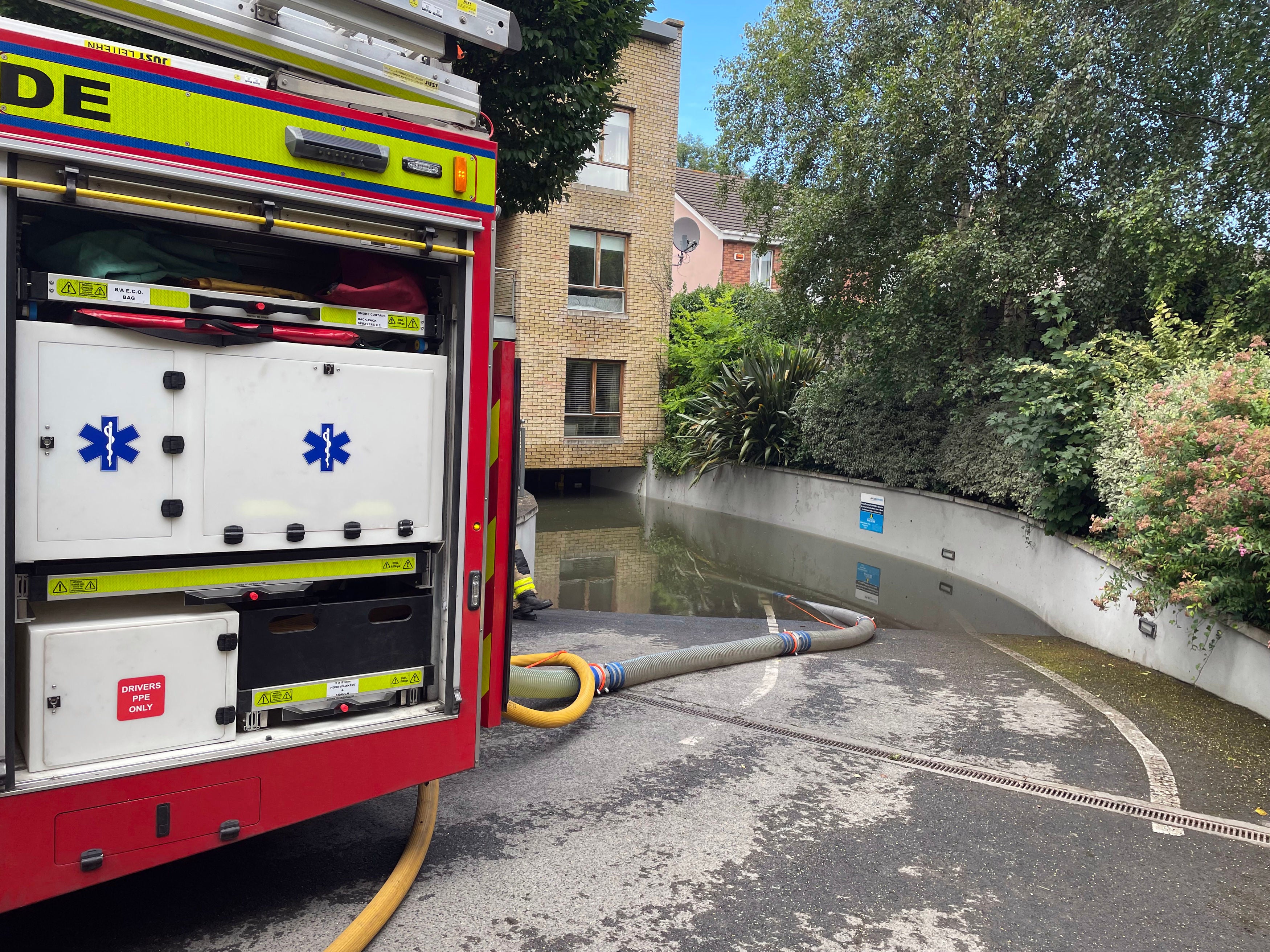 Workers from Dublin Fire Brigade and Dublin City Council drain an area in Clontarf, Dublin that was hit by flooding