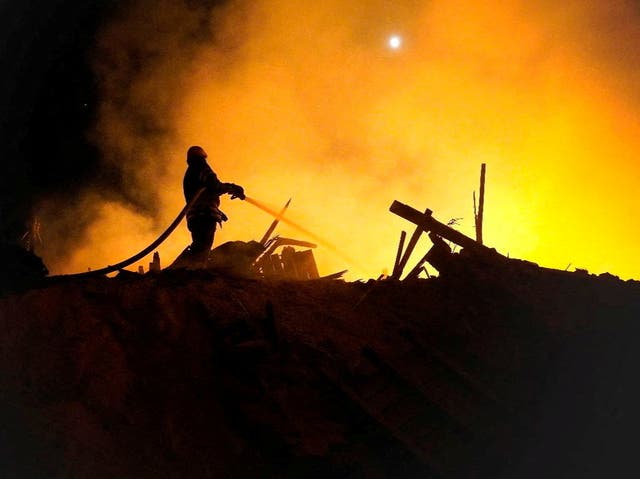 <p>A firefighter extinguishes a fire in the aftermath of an attack, amid Russia's attack on Ukraine, in the Starokostiantyniv, Khmelnytskyi Region</p>