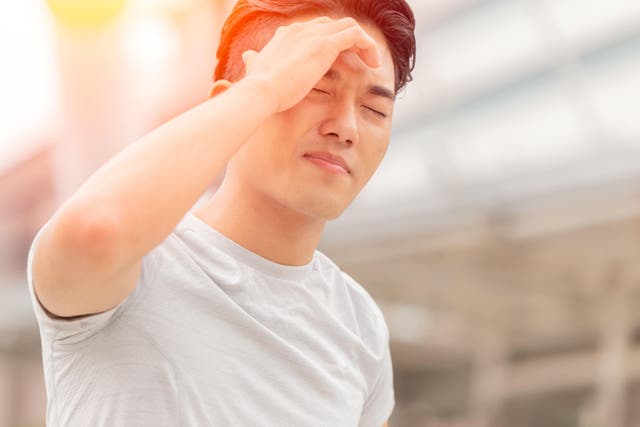 Heat exhaustion can cause headaches and dizziness (Alamy/PA)