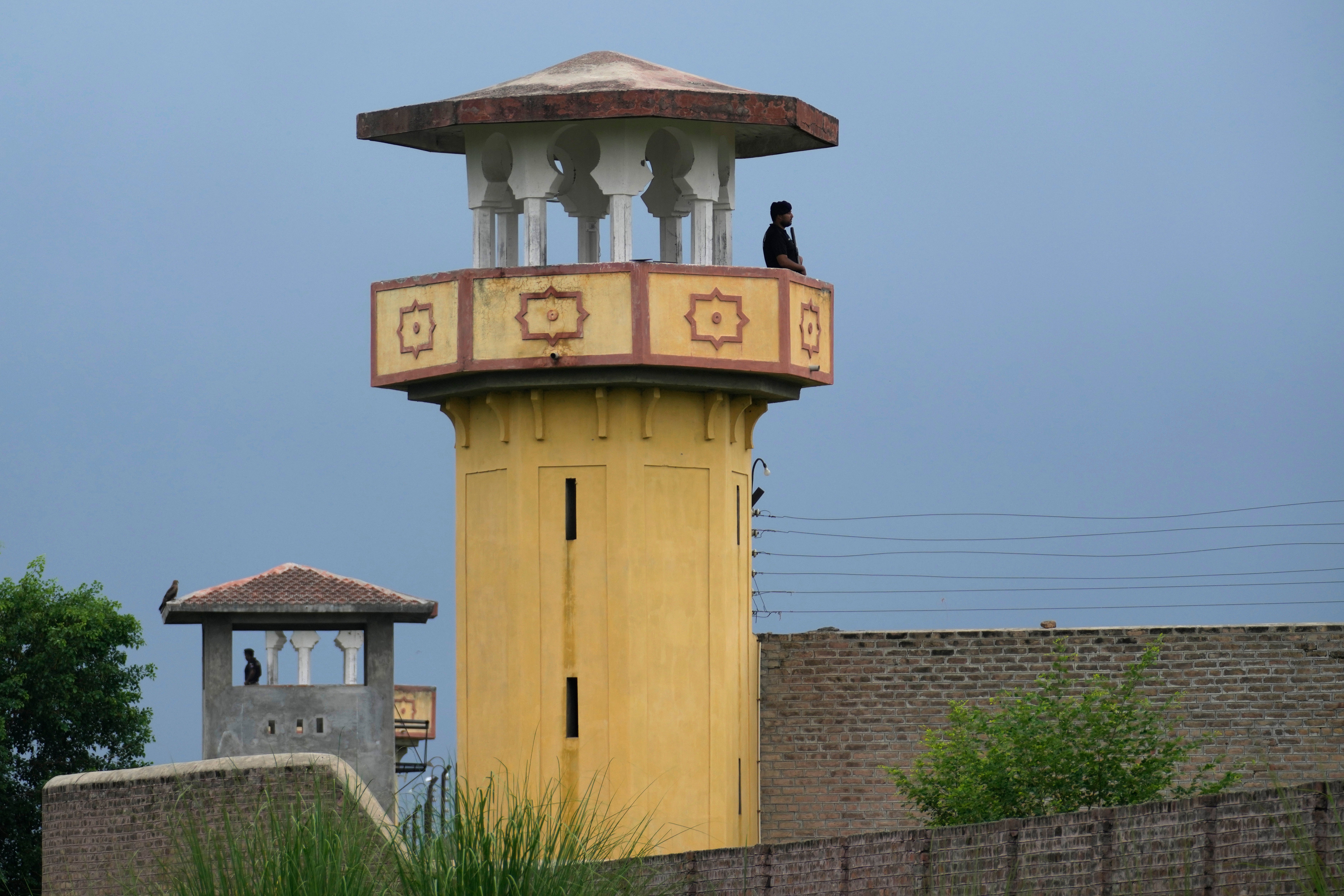 Police officers stand guard on the watchtowers of district prison Attock, where Pakistan’s former prime minister is being held