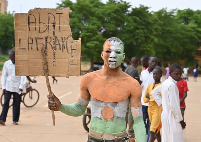 <p>A supporter of Niger’s coup, protests in Niamey</p>