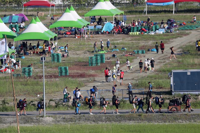 <p>Attendees of the World Scout Jamboree move to leave a scout camping site in Buan, South Korea on Tuesday</p>