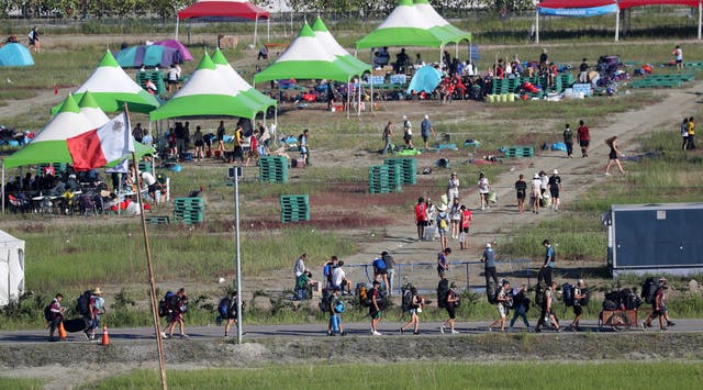 <p>Attendees of the World Scout Jamboree move to leave a scout camping site in Buan, South Korea on Tuesday</p>