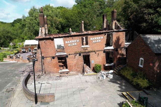<p>The burnt-out remains of The Crooked House pub near Dudley (Jacob King/PA)</p>