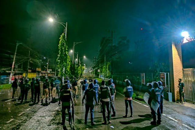 <p>Police personnel disperse an angry crowd during a clash after burning of Qurans in Sylhe</p>