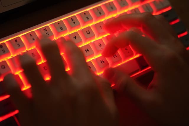 <p>In this photo illustration a young man types on an illuminated computer keyboard typically favored by computer coders on January 25, 2021 in Berlin, Germany</p>