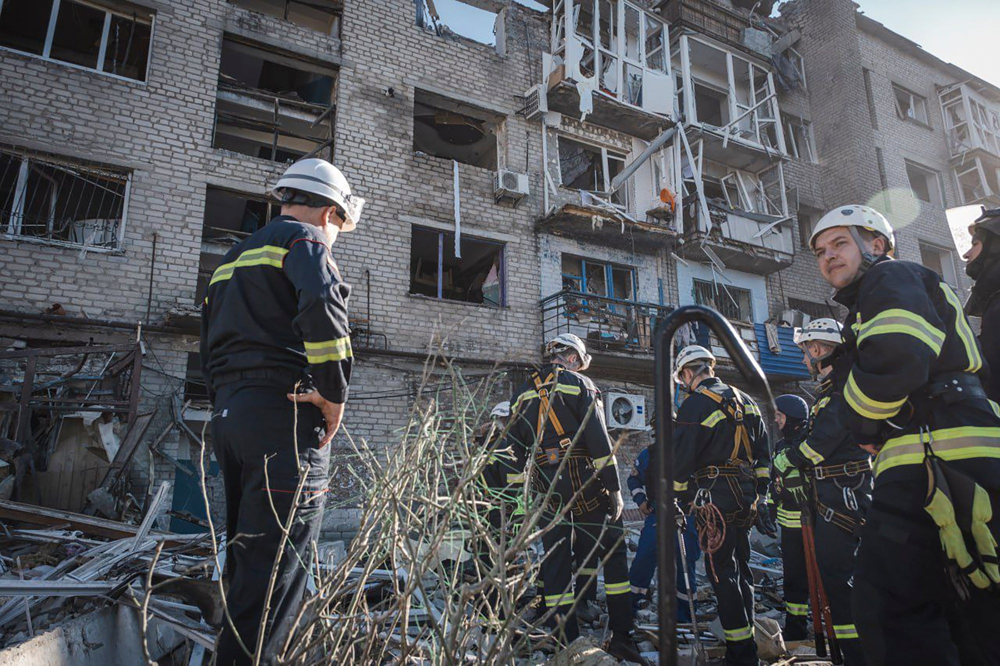 Rescue workers on the scene of a building damaged after Russian missile strikes in Pokrovsk, Donetsk