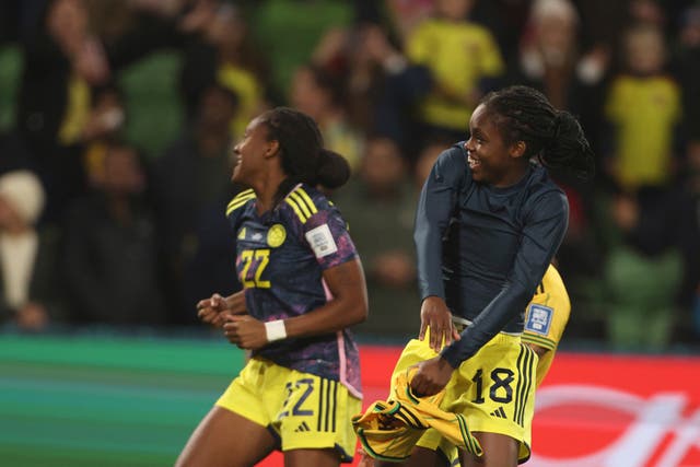 Linda Caicedo, right, and Daniela Caracas celebrate Colombia’s victory over Jamaica (Hamish Blair/AP)