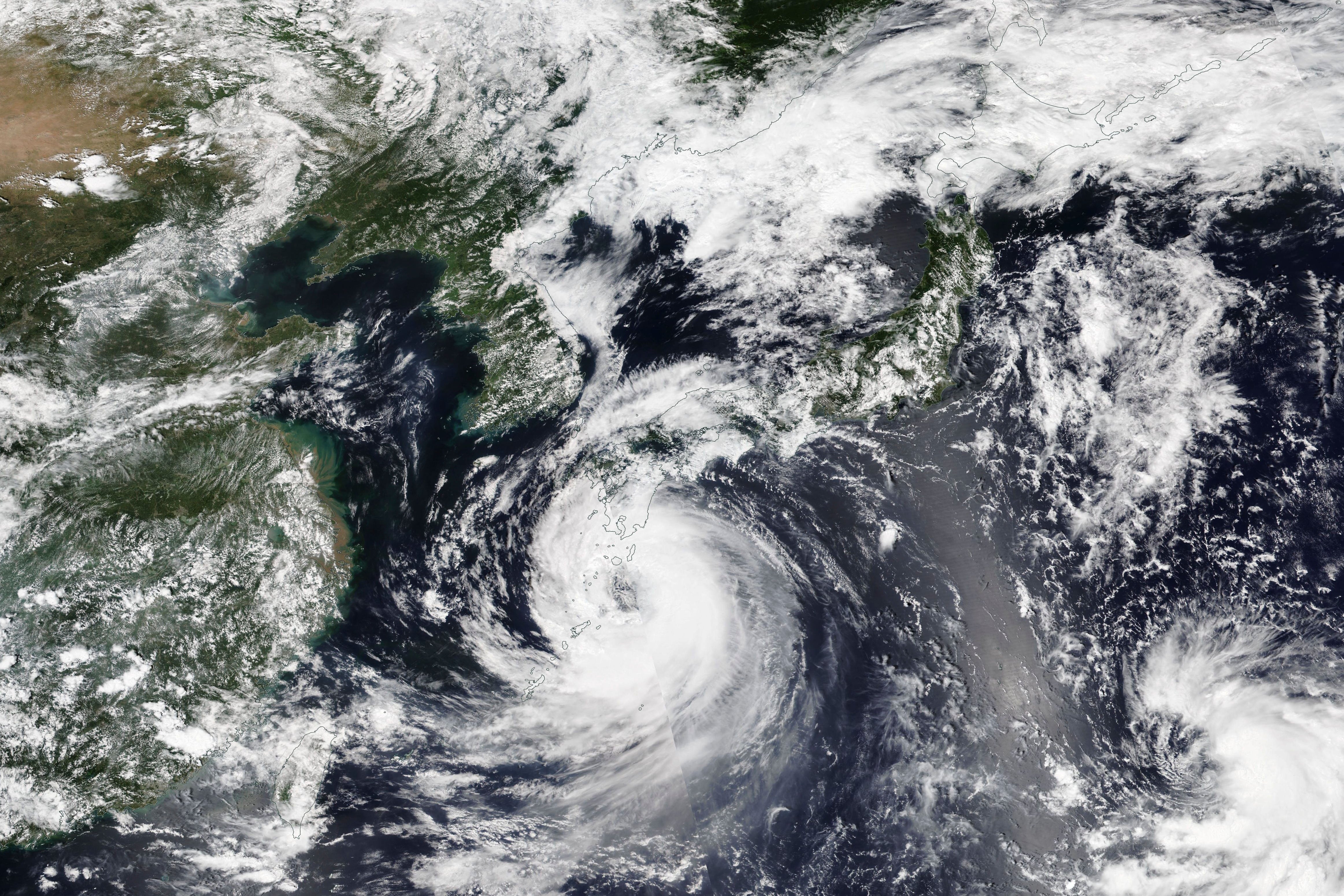 The final blow was Tropical Storm Khanun, seen here in a Nasa satellite image looming over Japan's southwestern islands