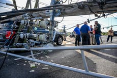 Storm-damaged communities in eastern US clear downed trees and race to restore power