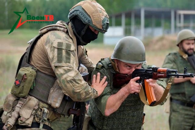 <p>A fighter from Russian Wagner mercenary group conducts training for Belarusian soldiers on a range near the town of Osipovichi, Belarus in July </p>