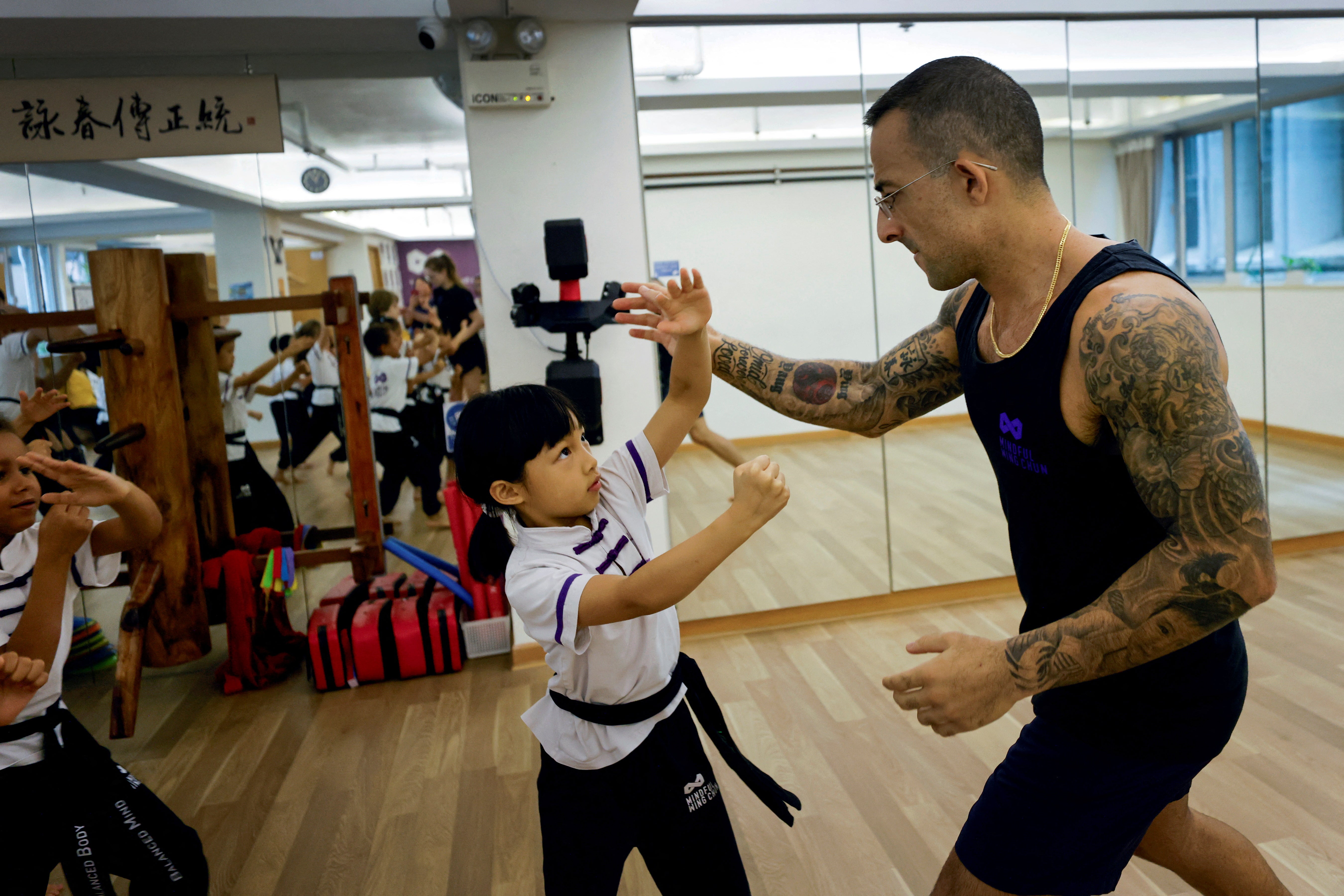 Nima King, 38, teaches Amber, seven, the principles of Wing Chun