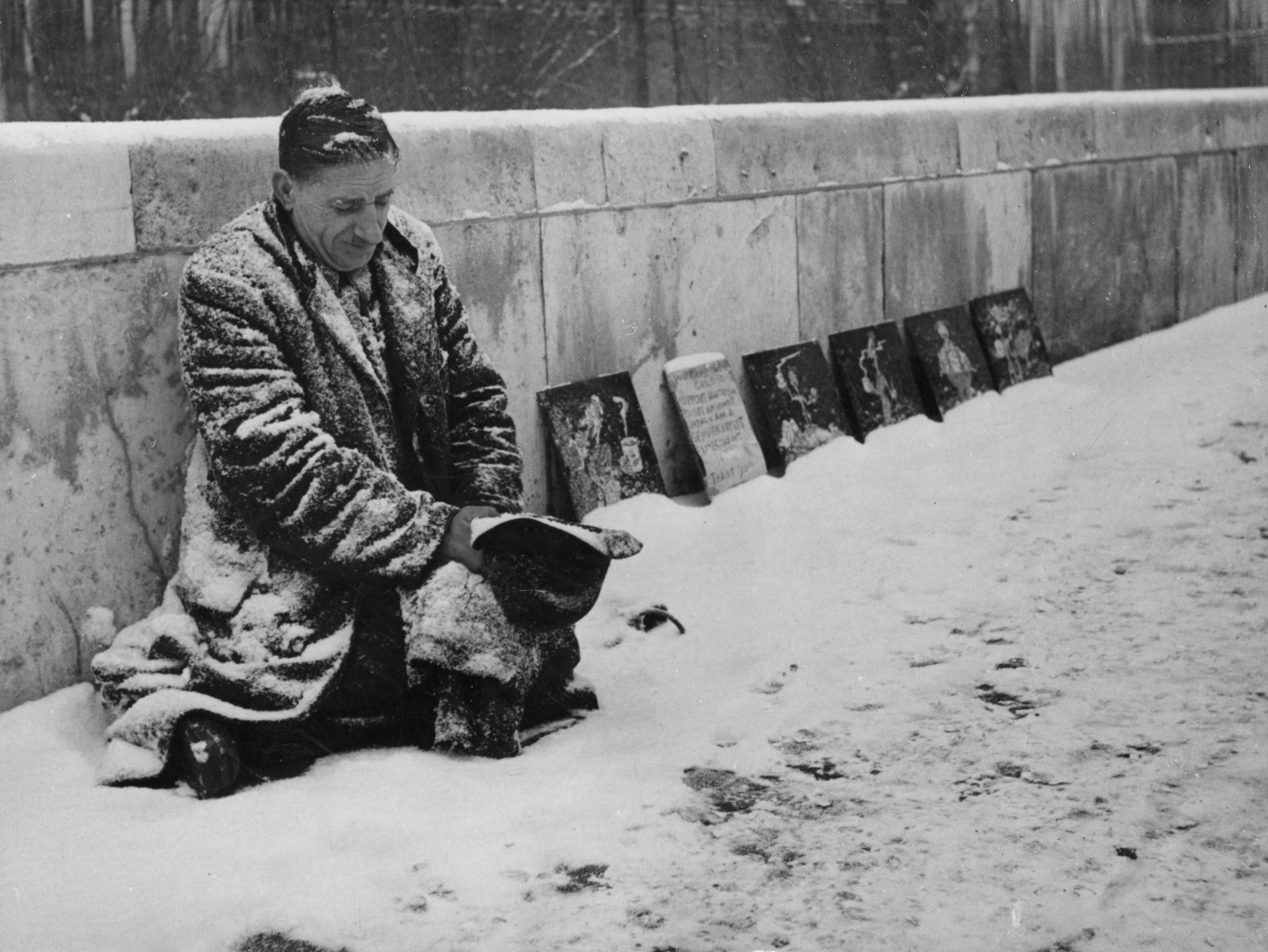 Albert Stewart, a pavement artist, on his snow-covered pitch outside the National Gallery in London in 1947