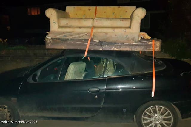 A sofa and mattress on the soft roof of a convertible car which Matthew Dummer was driving (Sussex Police/PA)
