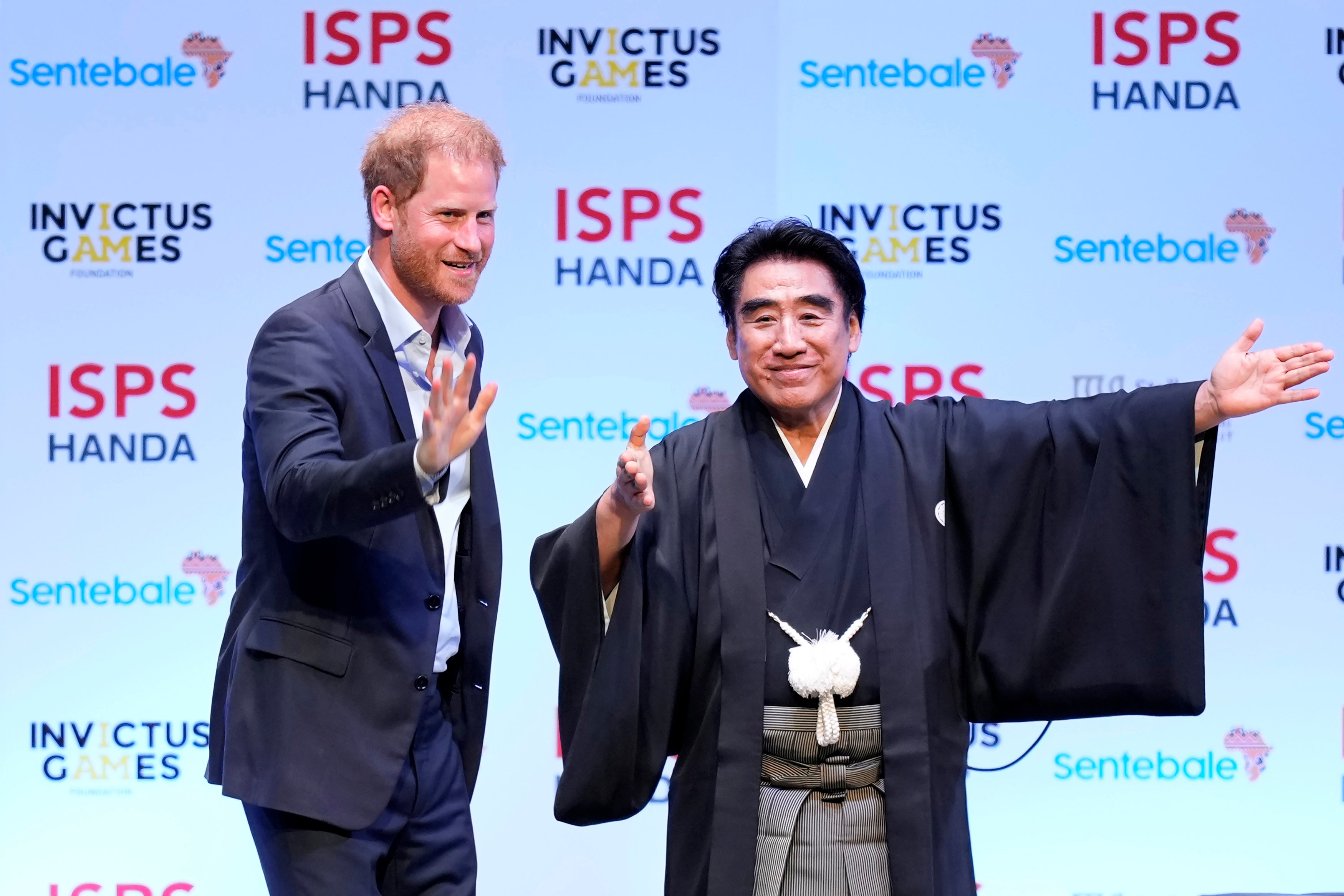 Prince Harry, escorted by Haruhisa Handa, CEO of the International Sports Promotion Society (ISPS), attends an event organized by the ISPS Wednesday, Aug. 9, 2023