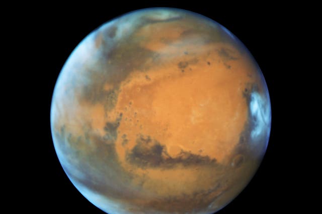 Mars is cold and inhospitable but evidence suggests it may have once had liquid water and a thick atmosphere (Nasa/ESA/PA)