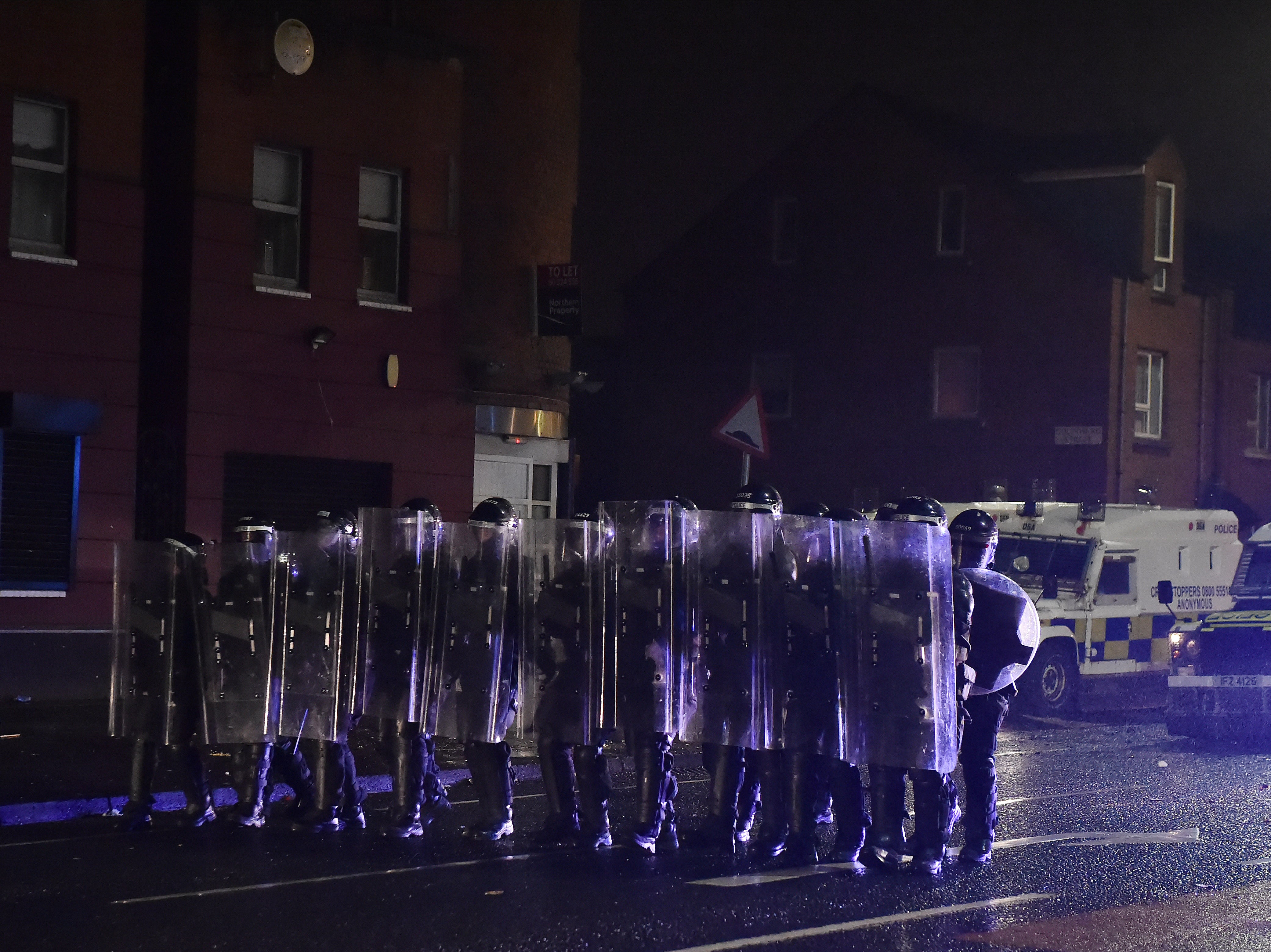 Police don riot shields as nationalists and loyalists riot in Belfast in April 2021