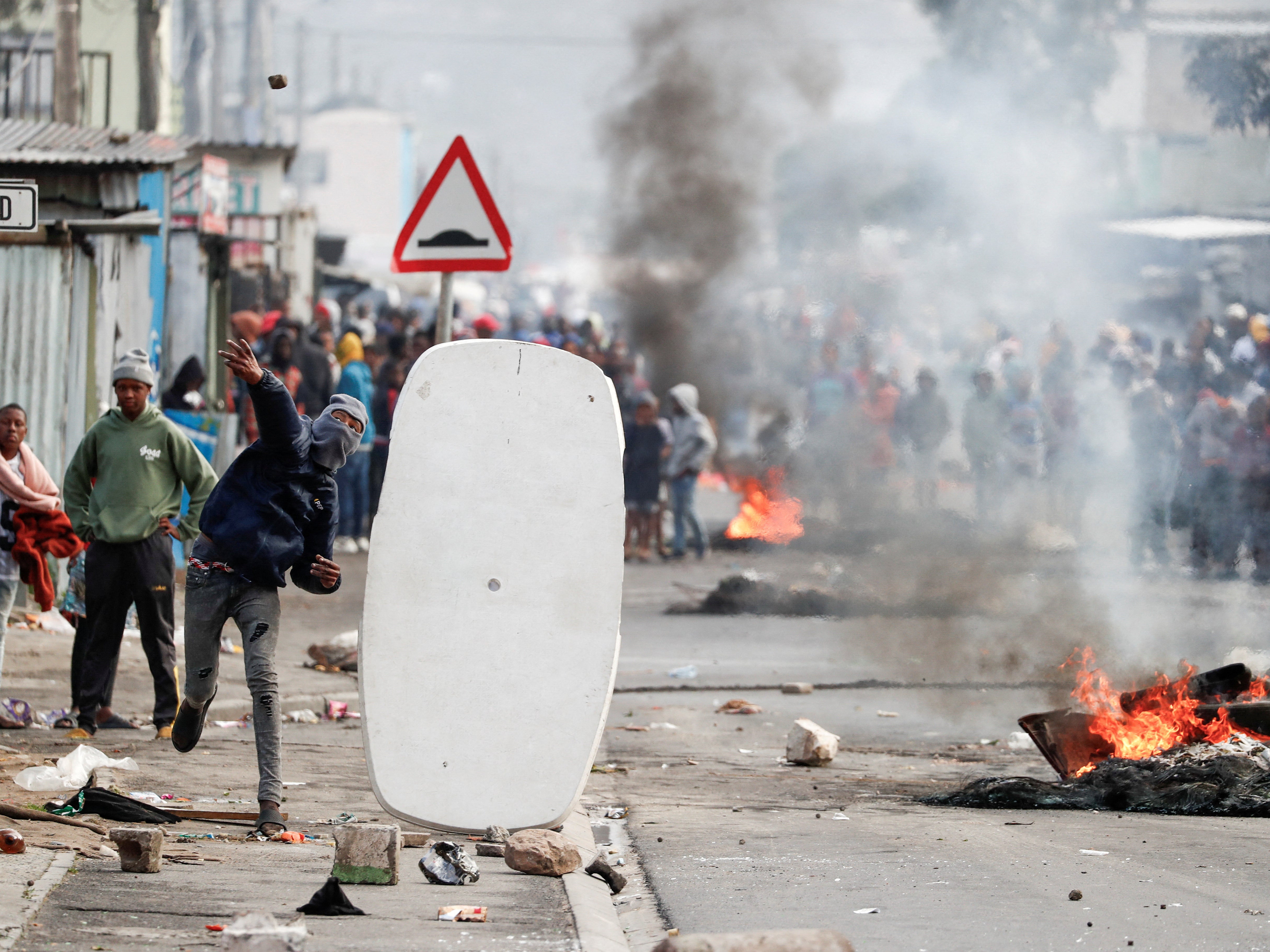 Residents of Masiphumelele throw rocks at police amidst an ongoing strike by taxi operators