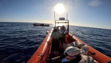 Migrants rescued from dinghy in Mediterranean as at least 41 dead in shipwreck off Italy