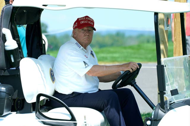 <p>Former US President and 2024 presidential hopeful Donald Trump drives a golf cart ahead of the LIV Golf Invitational series tournament at Trump National Golf Club Bedminster on 9 August 2023 </p>