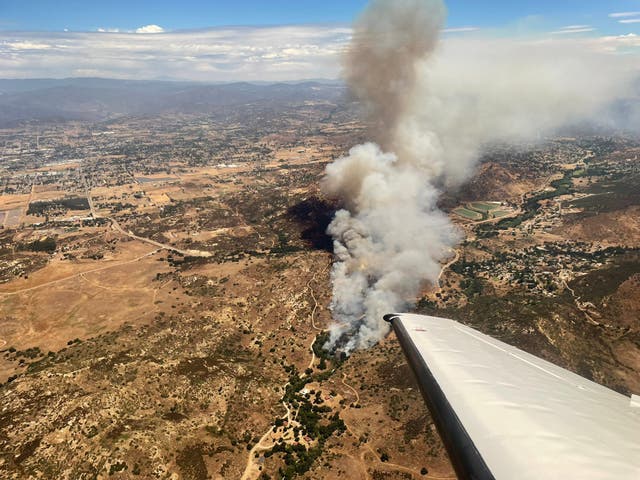 <p>The Bunnie Fire near Ramona, California, is seen from the air on 9 August, 2023</p>