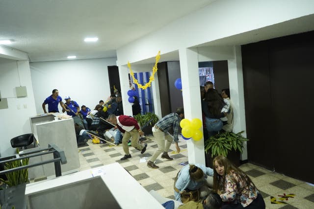 <p> Attendees at the rally for presidential candidate Fernando Villavicencio take shelter during the shooting in which the candidate was murdered</p>