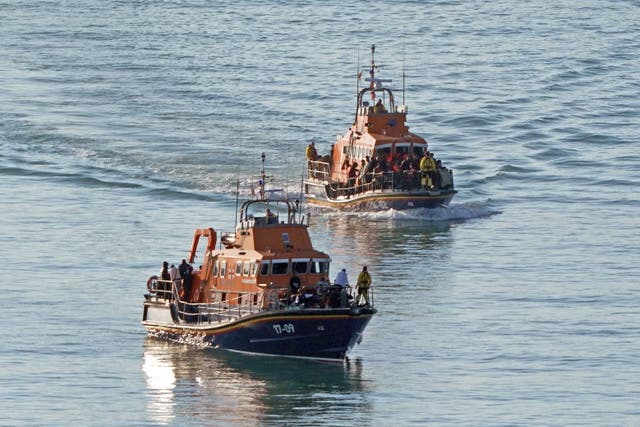 <p>A group of people thought to be migrants are brought in to Dover, Kent, onboard the Ramsgate Lifeboat and the Dover Lifeboat (Gareth Fuller/PA)</p>