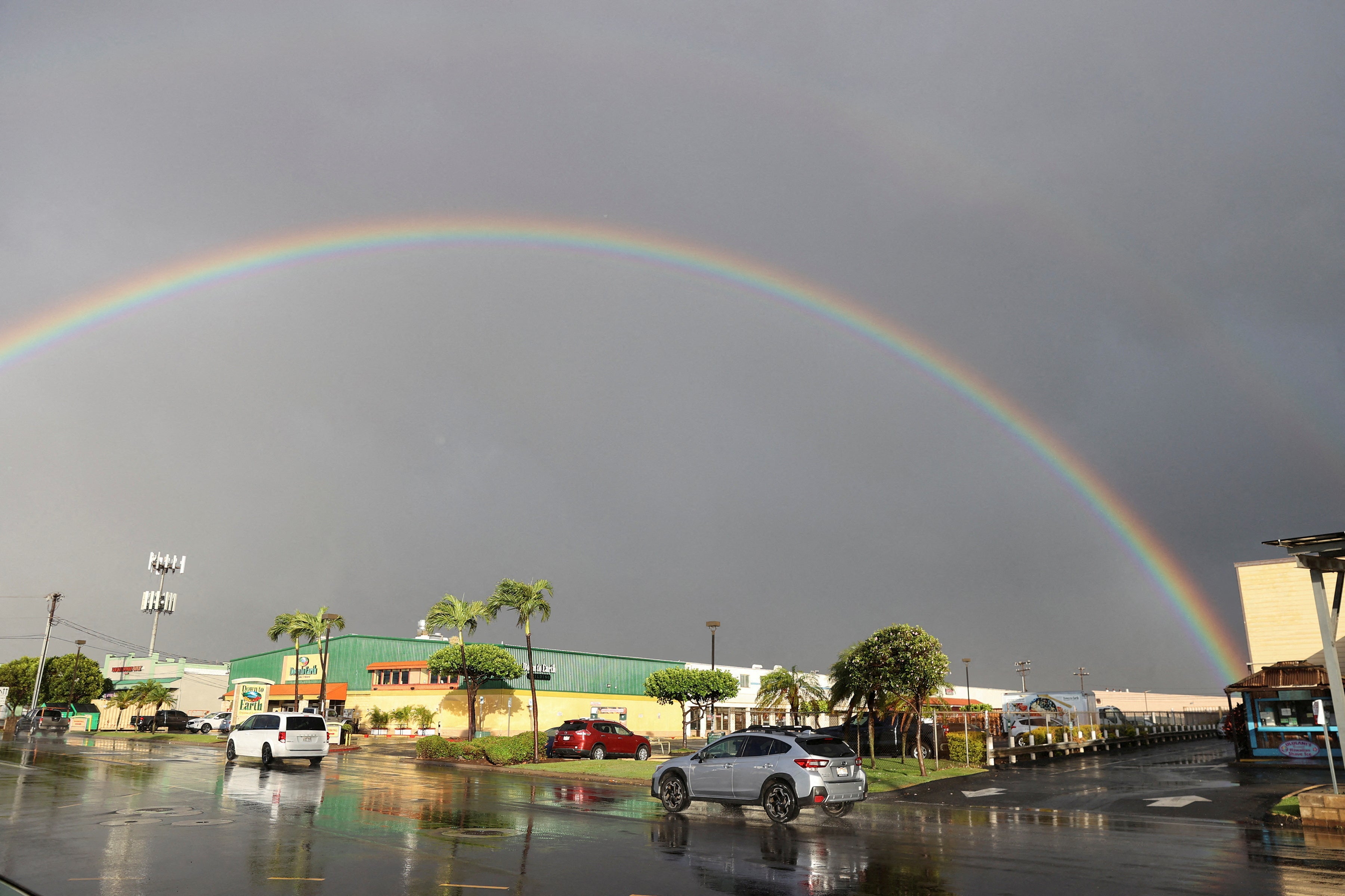 <p>A rainbow can be seen as rain falls over Maui in Kahului</p>