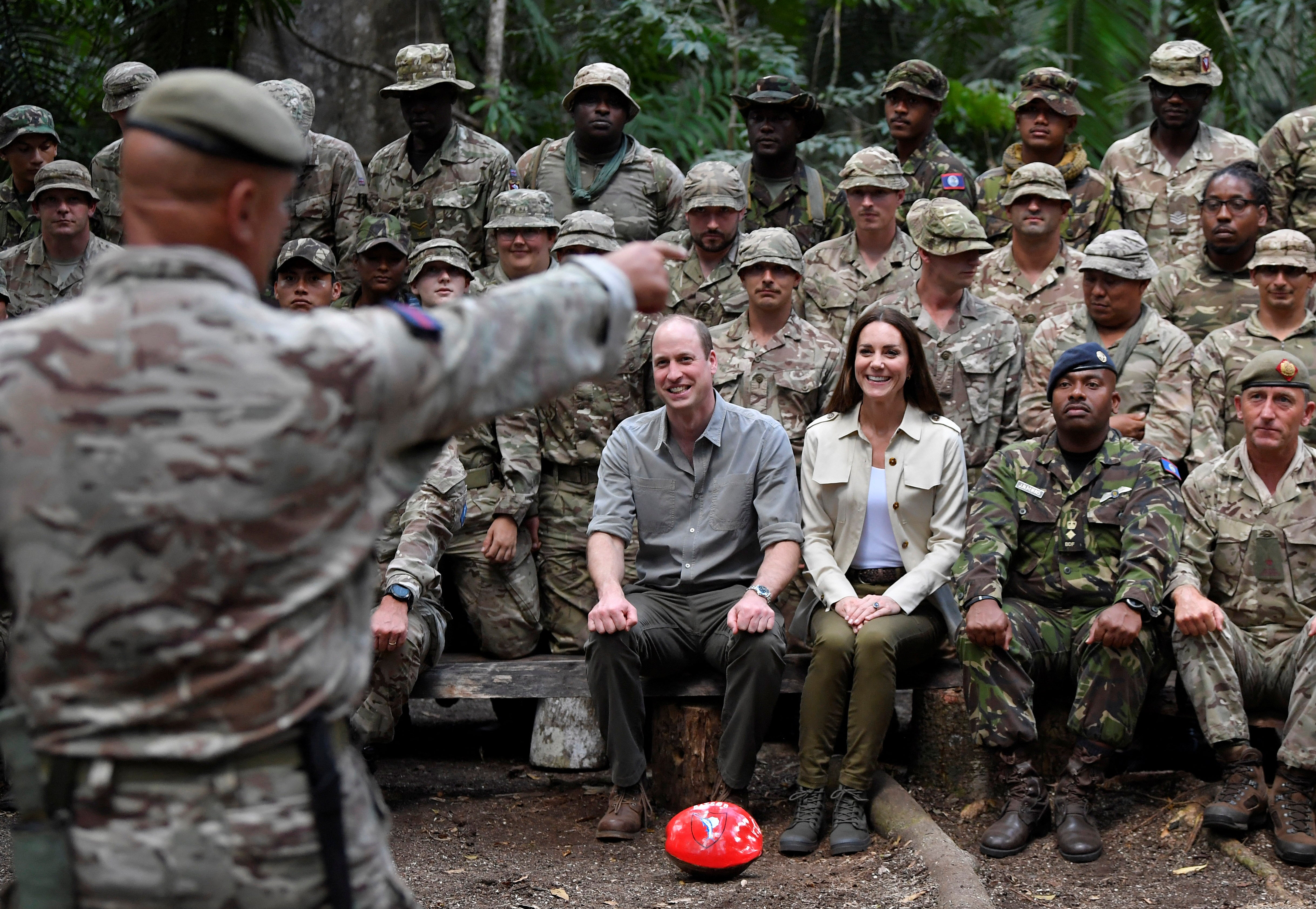 Prince William, Duke of Cambridge and Catherine, Duchess of Cambridge sit for a photo with military personnel from Britain and Belize during a visit to the British Army Training Support Unit (BATSUB) jungle training facility on the third day of a Platinum Jubilee Royal Tour to the Caribbean on March 21, 2022
