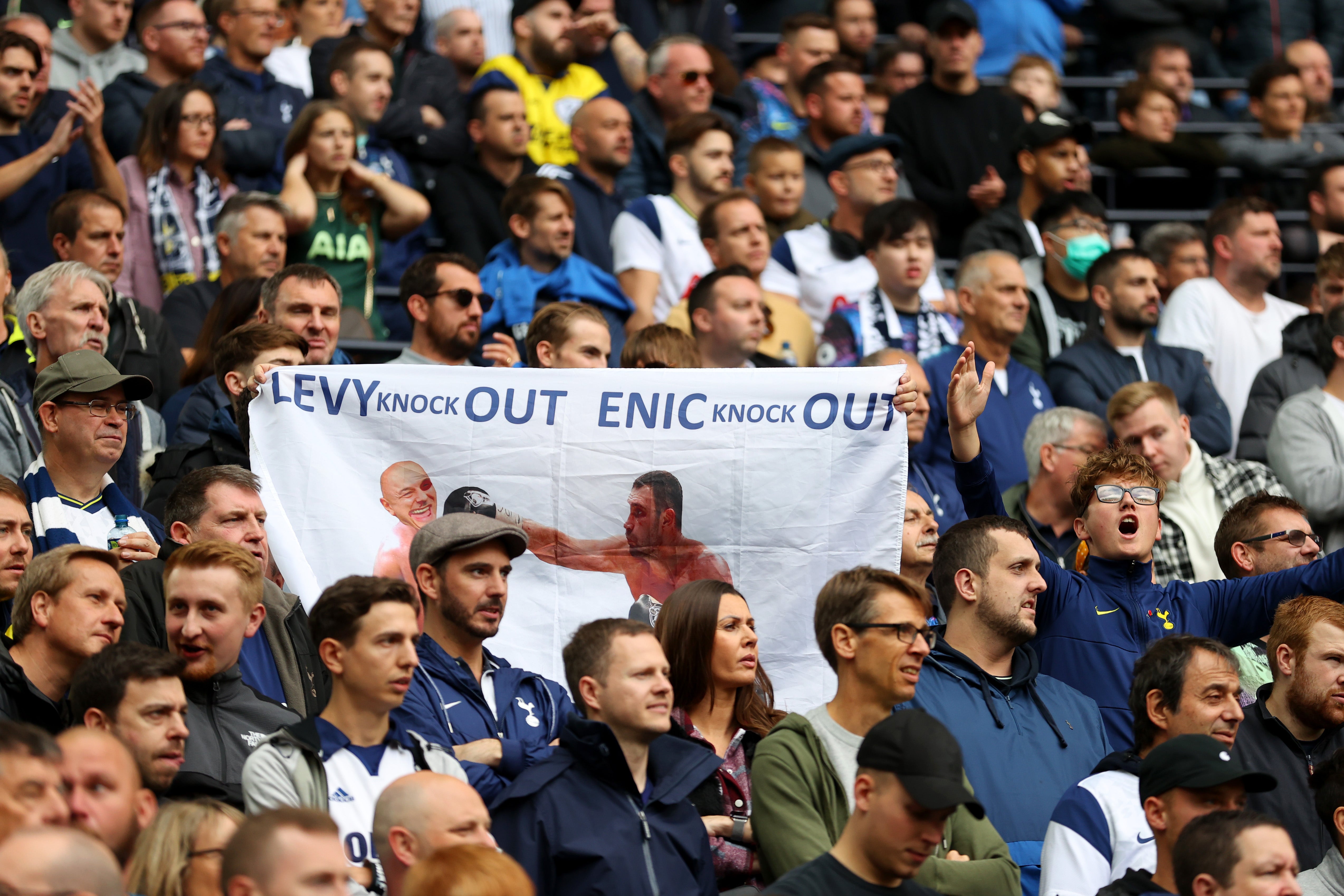 Tottenham fans hold a protest banner against chairman Daniel Levy and ENIC