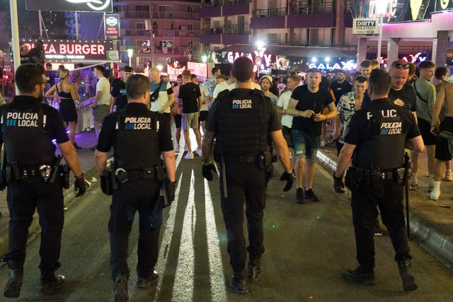 <p>Four police officers patrol in Punta Ballena street in the Magaluf holiday resort</p>