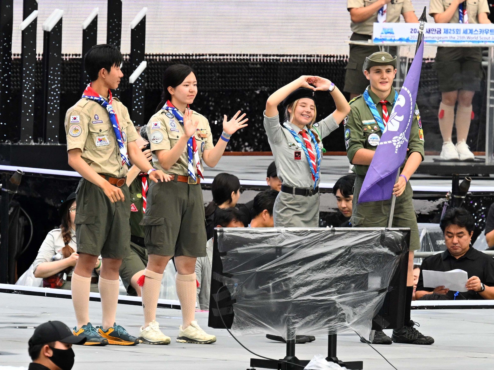 South Korean scouts hand over the scout flag to representatives from Poland, the host country for the next World Scout Jamboree, at the closing ceremony