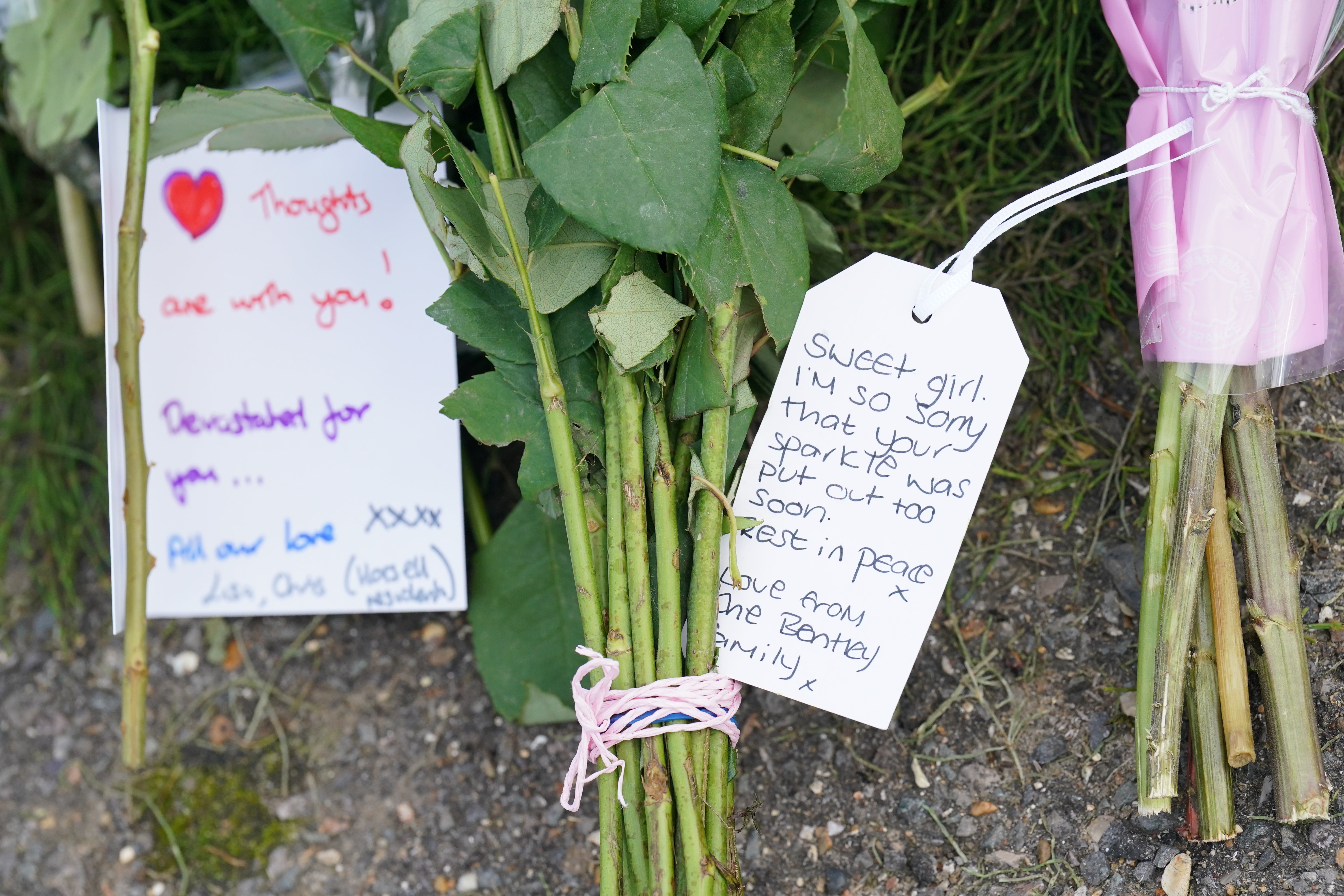 Notes left on flowers outside the house where the girl was found dead by police