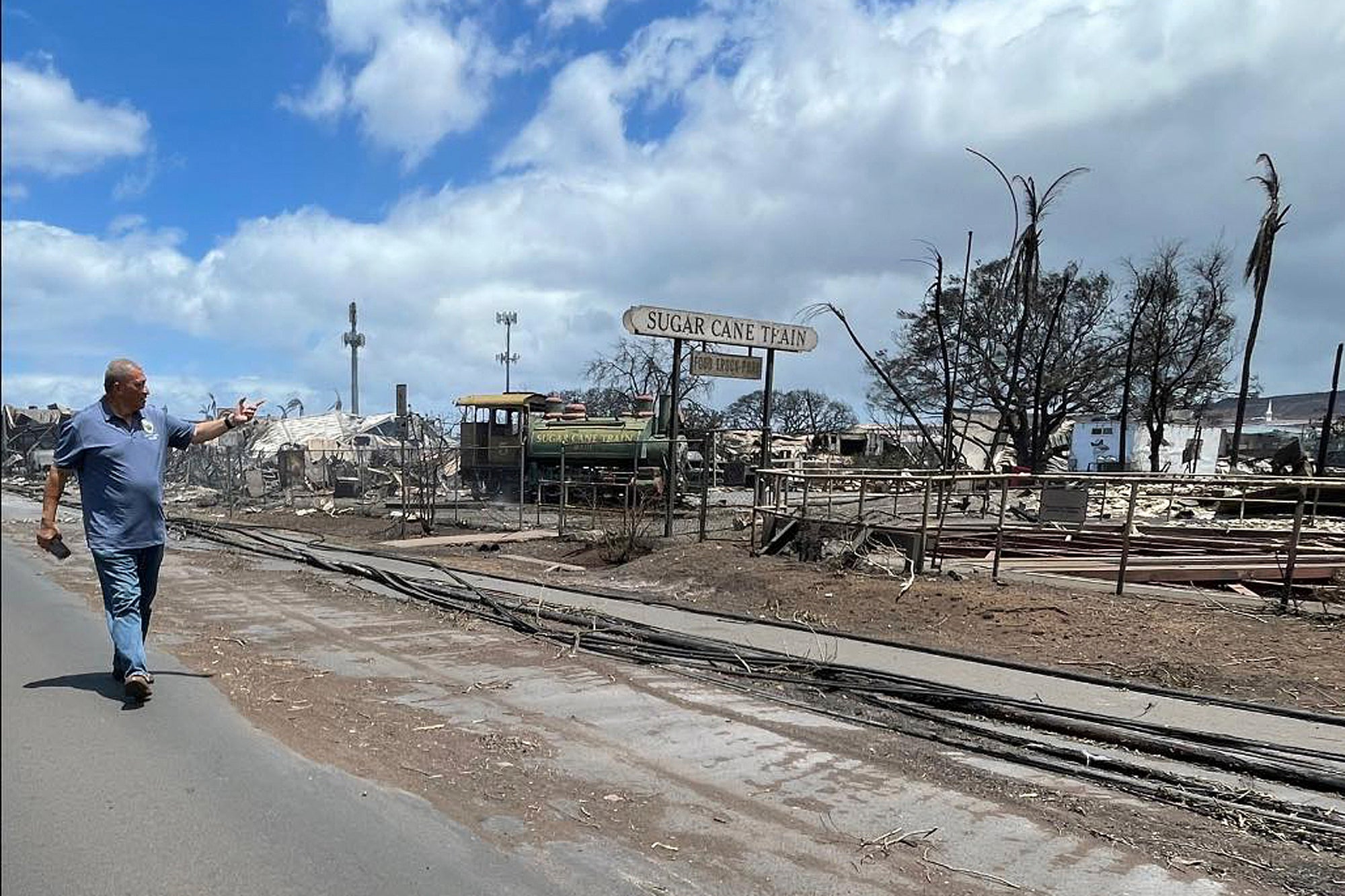 <p>Mayor Richard Bissen walks past the remains of the Sugar Cane Train depot in Lahaina, Hawaii, </p>