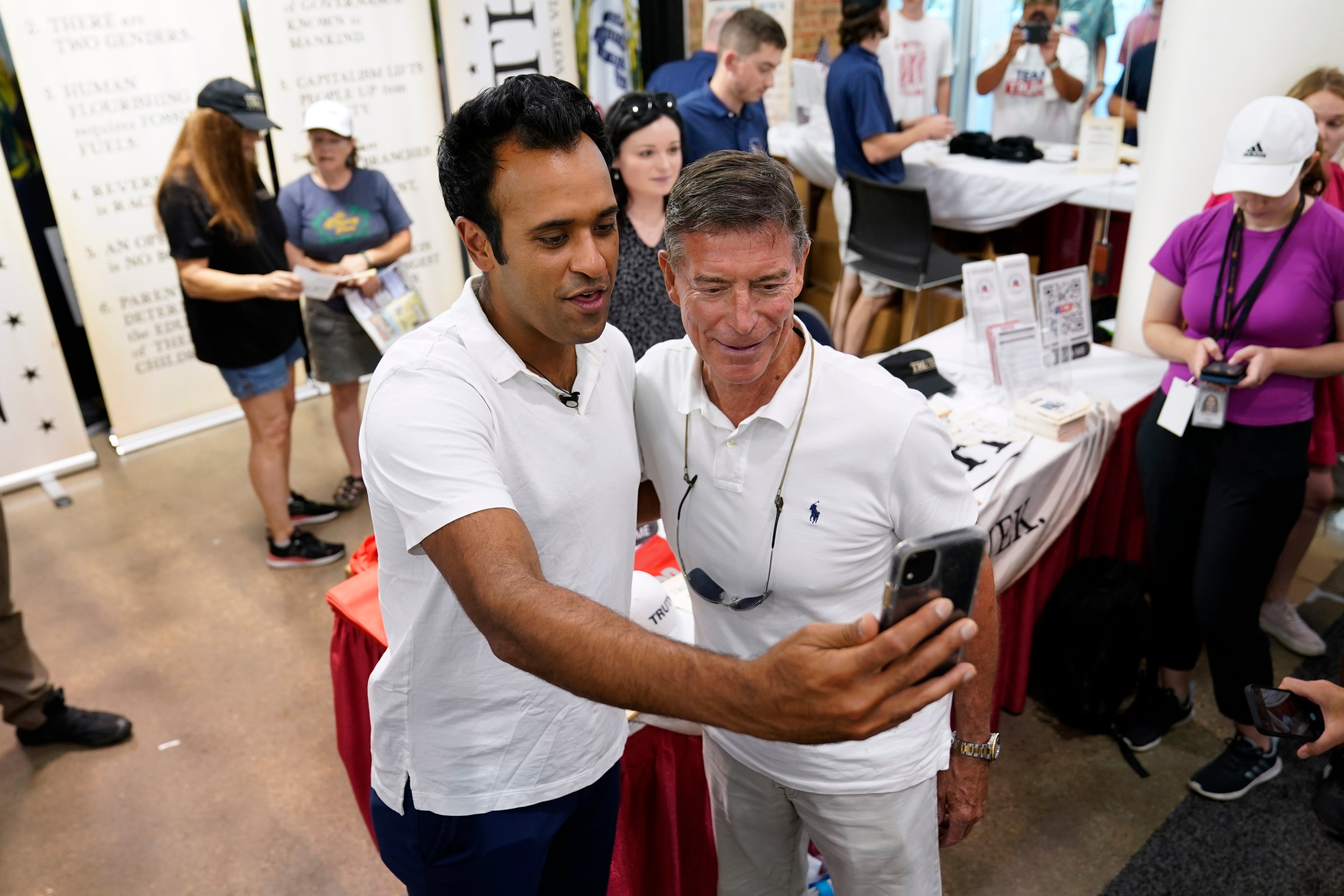 Republican presidential candidate businessman Vivek Ramaswamy poses for a photo with Chuck Ellis, right, of Birmingham, Alabama, at the Iowa State Fair, Friday, Aug. 11, 2023, in Des Moines, Iowa