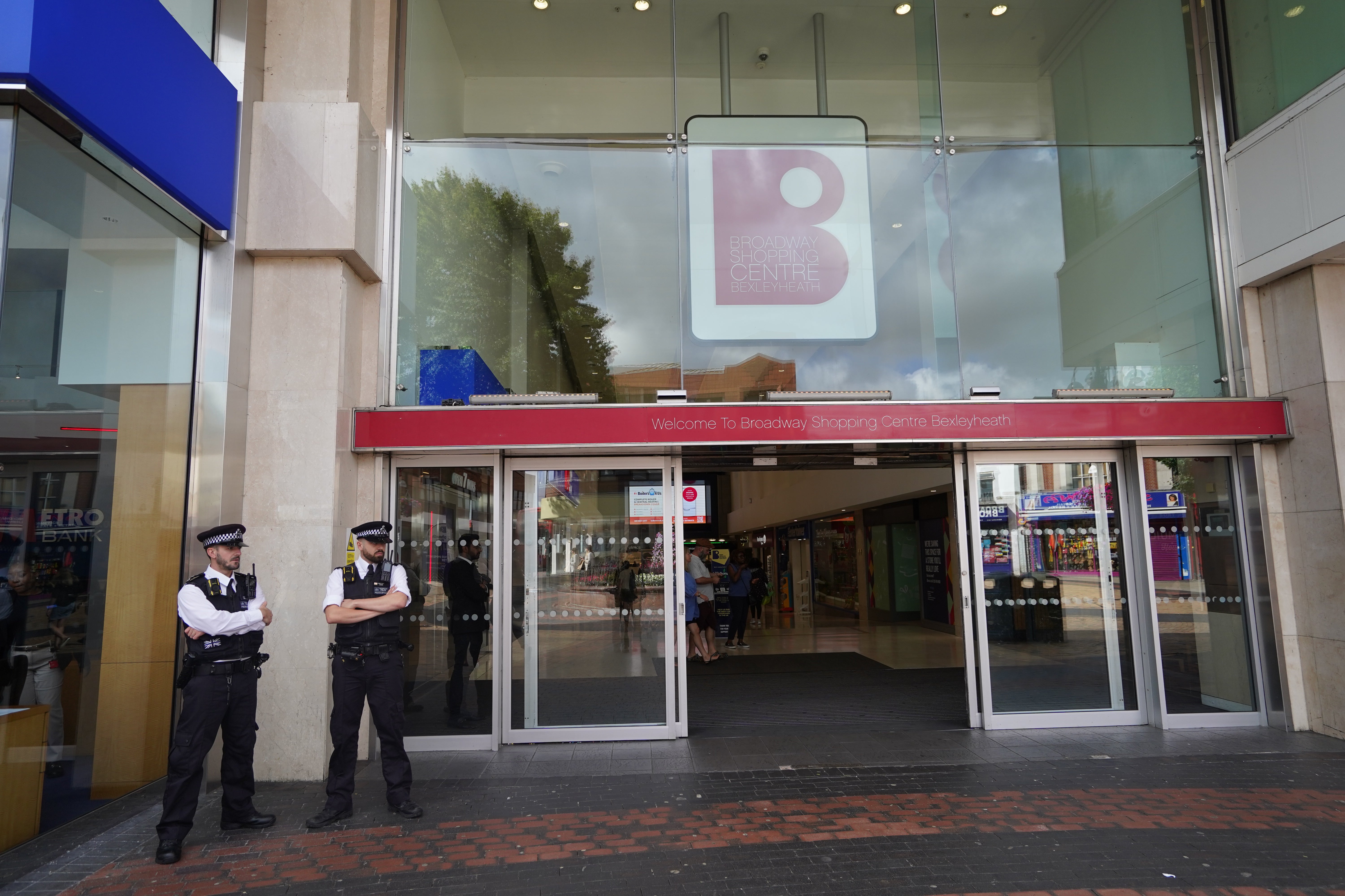 Police officers stand outside the Broadway Shopping Centre in Bexleyheath, southeast London, where businesses have been warned to prepare for "gangs of youths" to carry out an alleged TikTok-inspired raid